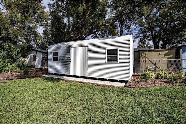 view of outdoor structure featuring a lawn