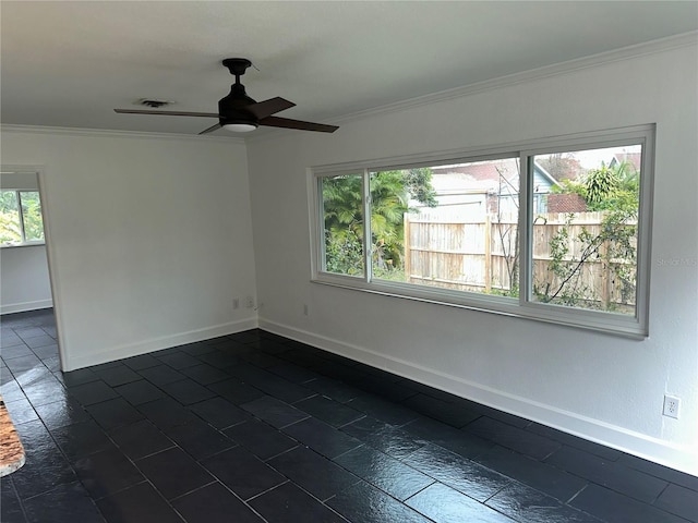 empty room featuring crown molding, a wealth of natural light, and ceiling fan