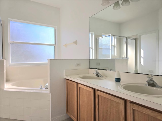 bathroom featuring vanity and separate shower and tub