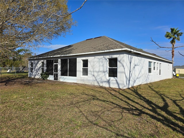 rear view of property featuring a yard