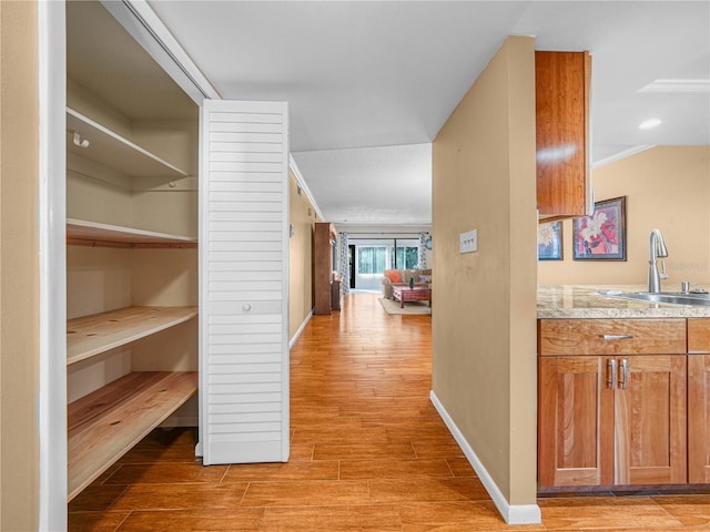 2002 Granada Ct Unit 1, Lake Wales, FL 33898 - hallway with ornamental molding, light hardwood / wood-style flooring, and sink