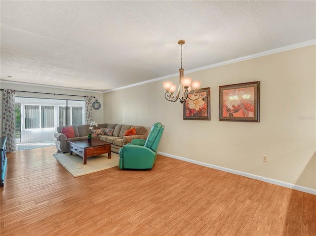 2002 Granada Ct Unit 1, Lake Wales, FL 33898 - living room featuring light wood-type flooring, an inviting chandelier, crown molding, and a textured ceiling