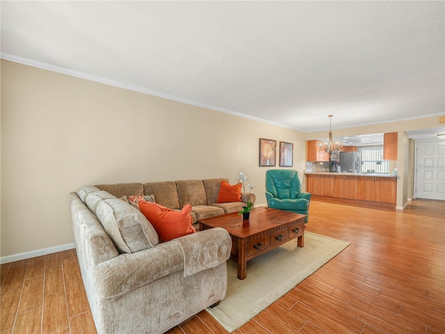 2002 Granada Ct Unit 1, Lake Wales, FL 33898 - living room with ornamental molding, a chandelier, and light hardwood / wood-style floors