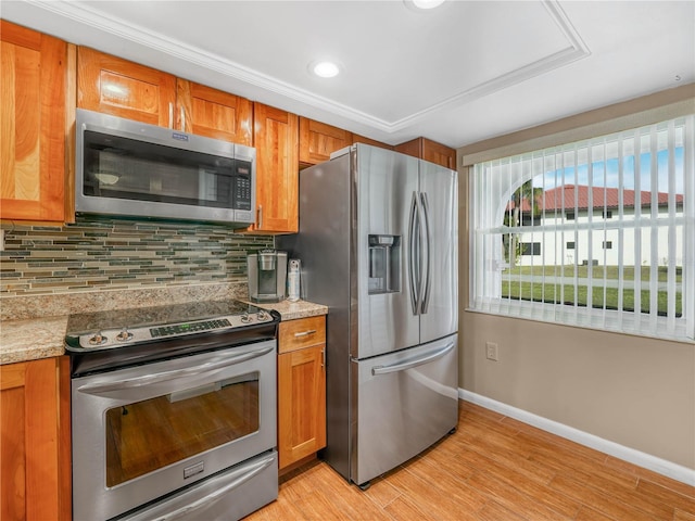 2002 Granada Ct Unit 1, Lake Wales, FL 33898 - kitchen with light hardwood / wood-style flooring, tasteful backsplash, stainless steel appliances, and light stone counters