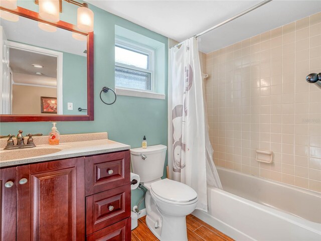 2002 Granada Ct Unit 1, Lake Wales, FL 33898 - full bathroom featuring shower / tub combo with curtain, toilet, vanity, and wood-type flooring