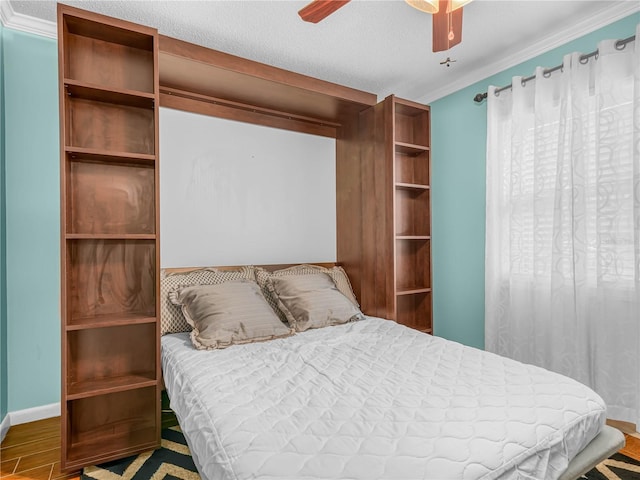 2002 Granada Ct Unit 1, Lake Wales, FL 33898 - bedroom with a textured ceiling, hardwood / wood-style floors, crown molding, and ceiling fan