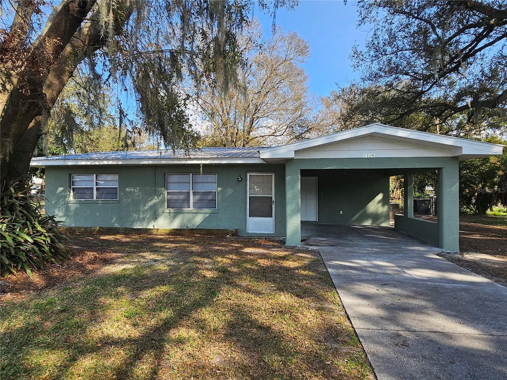 ranch-style house with a carport