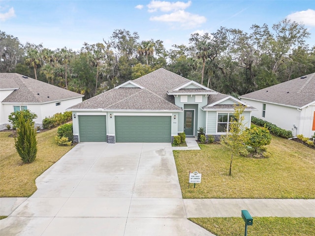 view of front of house featuring a garage and a front lawn