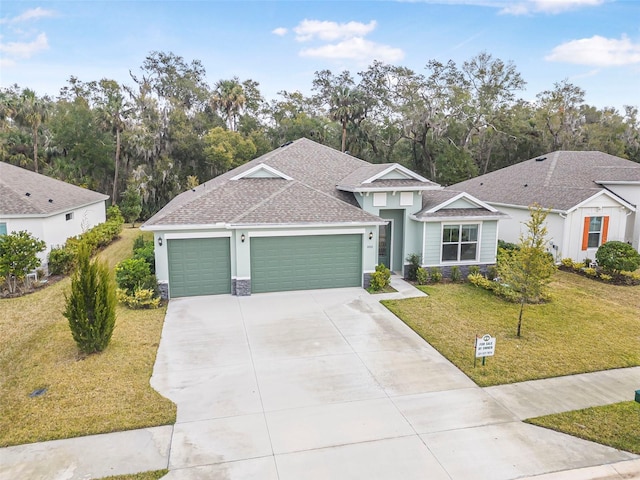 view of front of home with a garage and a front lawn