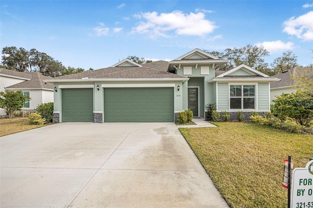 view of front of property featuring a garage and a front yard