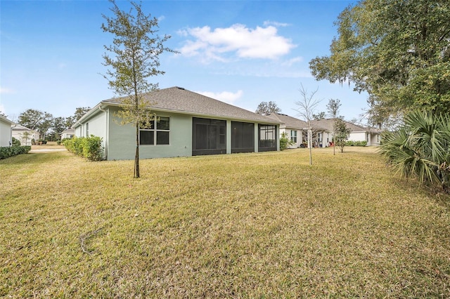 rear view of house with a lawn