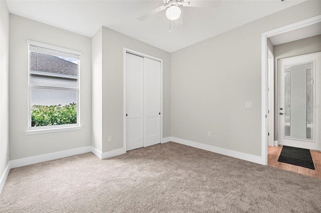 unfurnished bedroom featuring a closet, ceiling fan, and carpet flooring