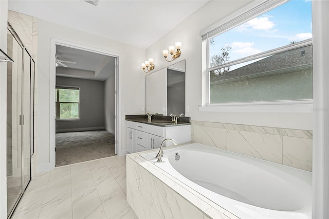 bathroom featuring vanity and tiled bath