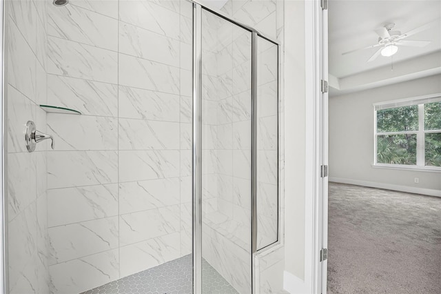 bathroom with a shower with shower door and ceiling fan