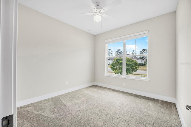 carpeted spare room with ceiling fan