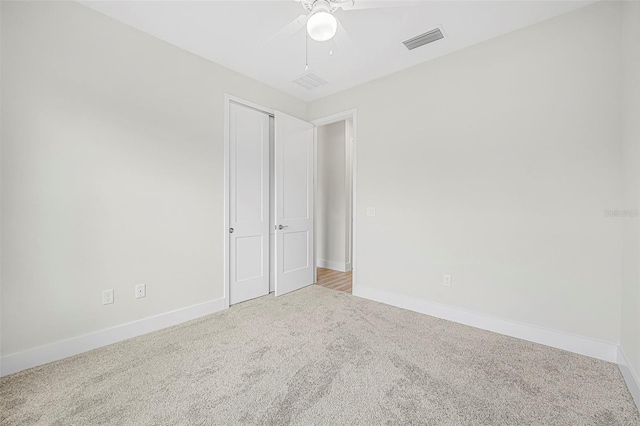 unfurnished room featuring carpet and ceiling fan