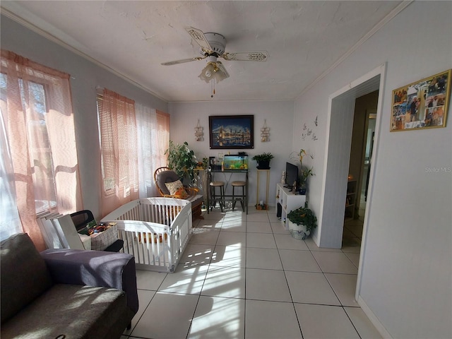 interior space with ornamental molding and ceiling fan