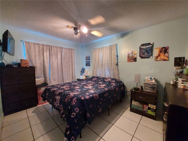 tiled bedroom featuring ceiling fan