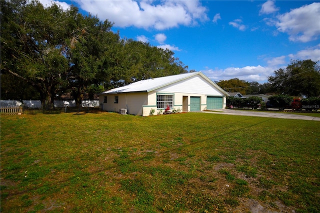 single story home with central AC unit, a garage, and a front lawn