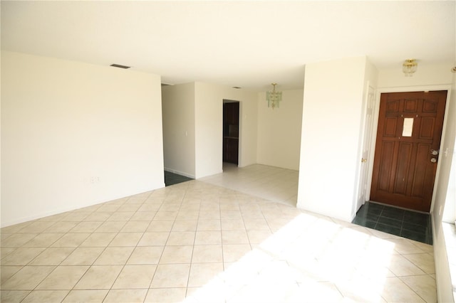 spare room featuring light tile patterned floors