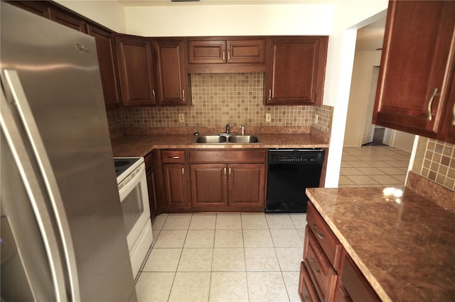 kitchen with sink, tasteful backsplash, electric range, stainless steel refrigerator, and dishwasher