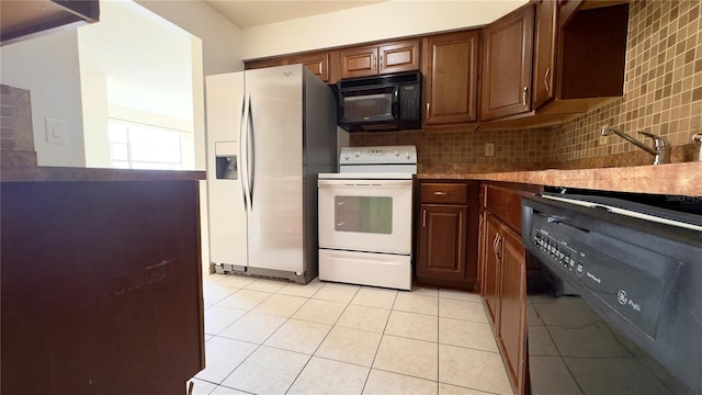 kitchen featuring decorative backsplash, black appliances, and light tile patterned flooring