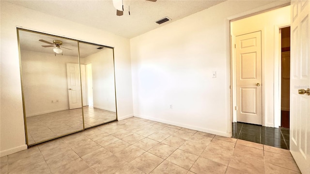 unfurnished bedroom featuring a closet and ceiling fan