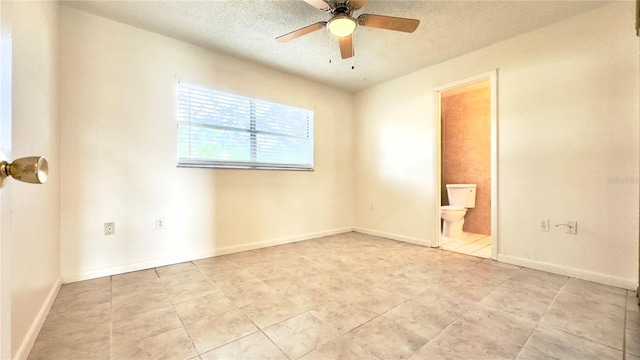 spare room featuring ceiling fan and a textured ceiling