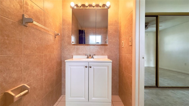 bathroom featuring vanity, ceiling fan, tile patterned floors, and tile walls