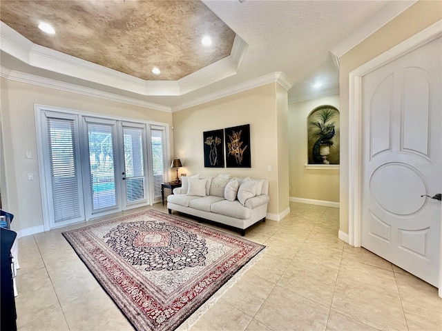 living room with crown molding, a tray ceiling, french doors, and light tile patterned floors