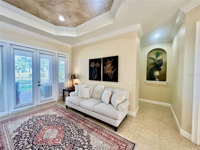 tiled living room featuring french doors, crown molding, and a tray ceiling