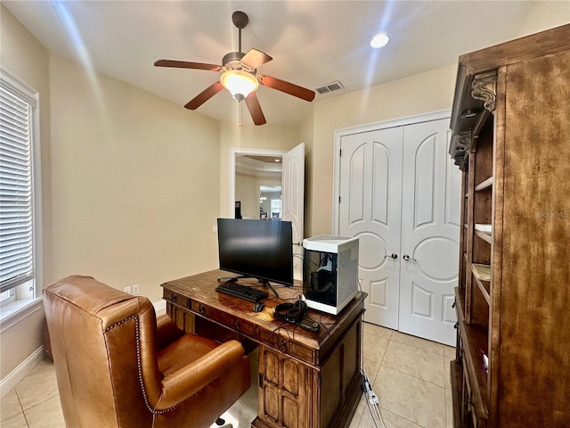 tiled home office featuring ceiling fan and a healthy amount of sunlight