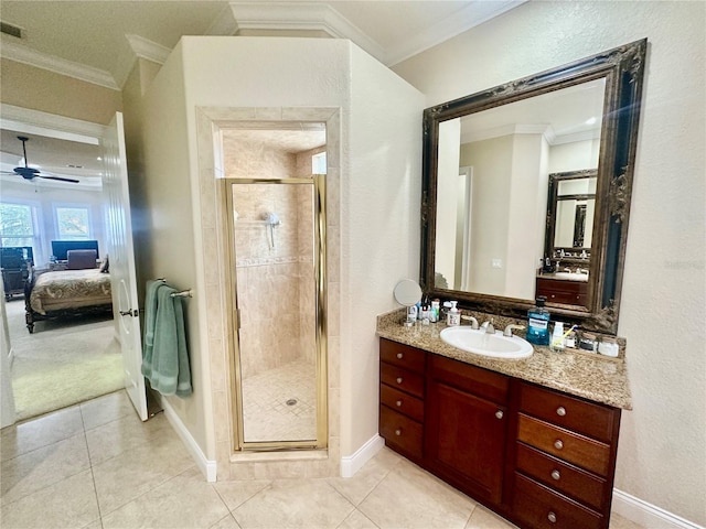 bathroom featuring vanity, tile patterned flooring, a shower with door, and ornamental molding