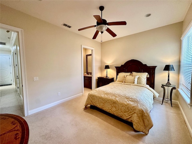 carpeted bedroom with ceiling fan, connected bathroom, and multiple windows