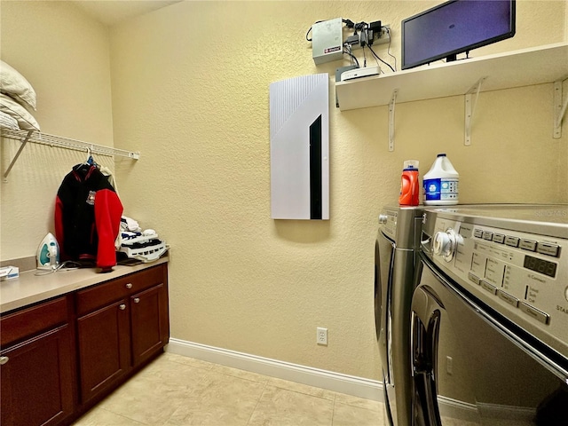 laundry room with light tile patterned flooring and washing machine and dryer