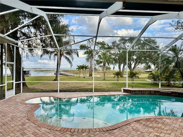 view of pool with a water view, a patio, a lanai, and a yard