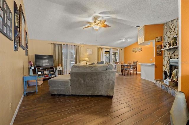 living room with ceiling fan, lofted ceiling, a textured ceiling, and dark hardwood / wood-style flooring