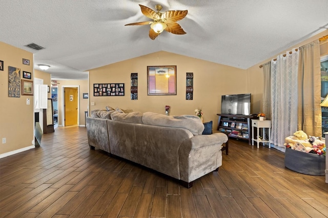 living room with vaulted ceiling, dark hardwood / wood-style floors, ceiling fan, and a textured ceiling