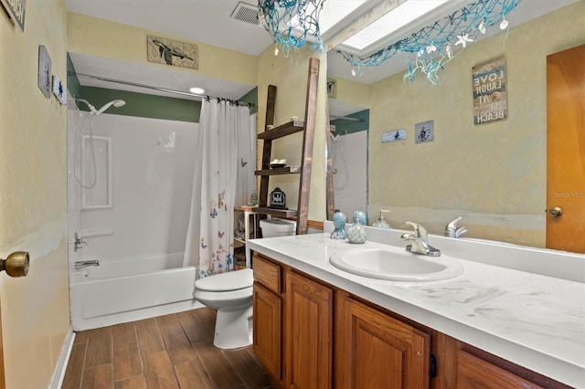 full bathroom with hardwood / wood-style flooring, shower / bath combo, vanity, and toilet