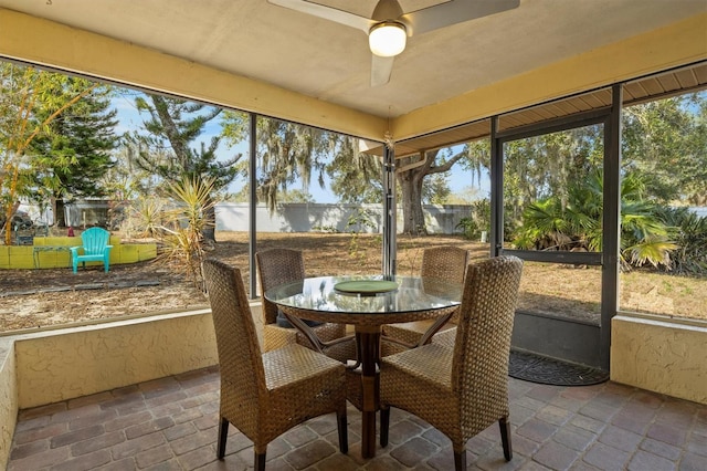 sunroom / solarium featuring ceiling fan