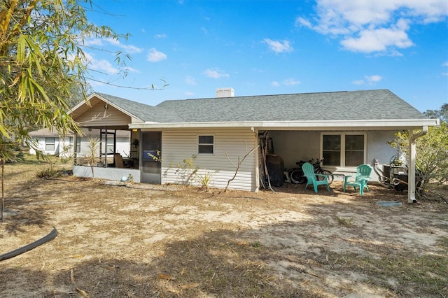 rear view of property with a sunroom