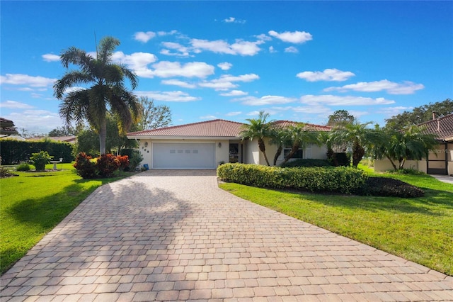 view of front of property featuring a garage and a front lawn