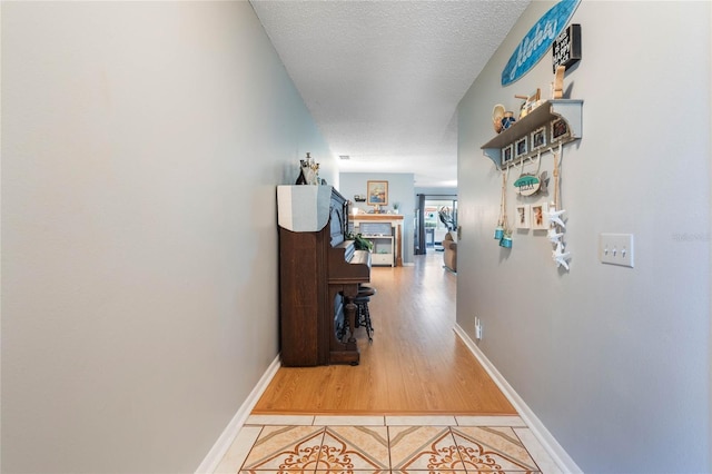 corridor featuring hardwood / wood-style flooring and a textured ceiling