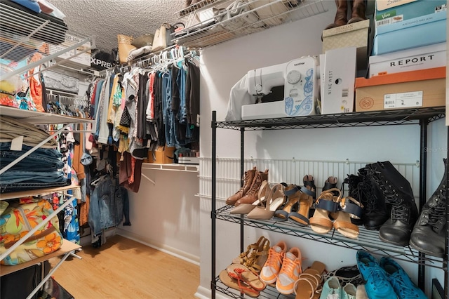 walk in closet with hardwood / wood-style floors