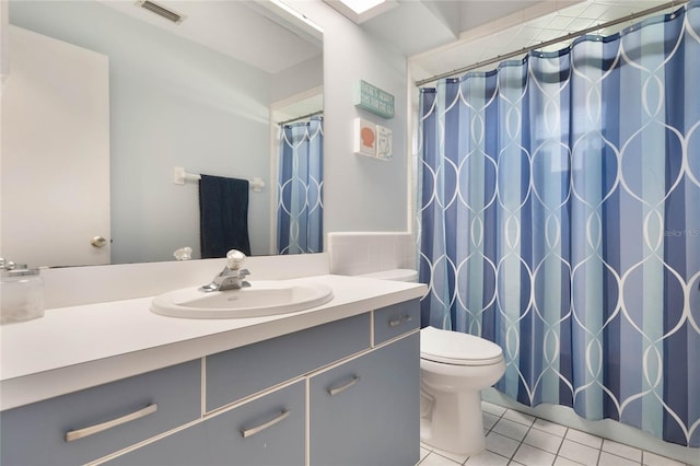 bathroom featuring tile patterned floors, toilet, and vanity