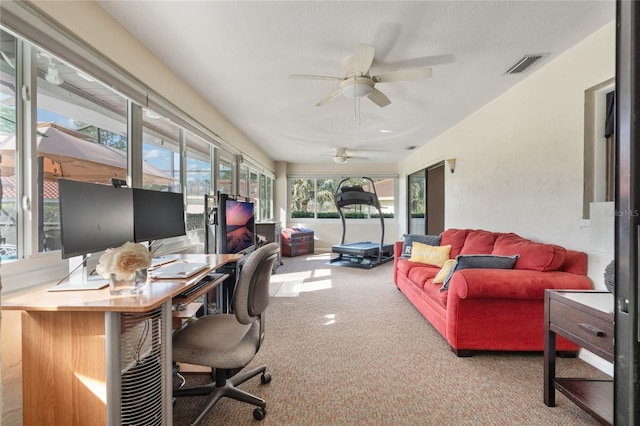 carpeted office with ceiling fan and a textured ceiling