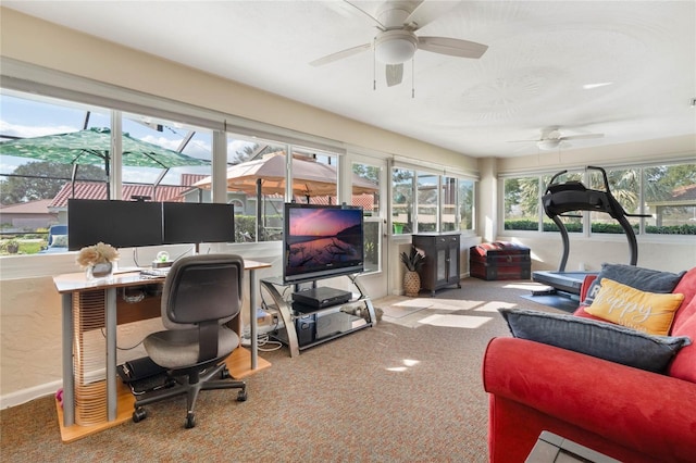 carpeted office space with ceiling fan