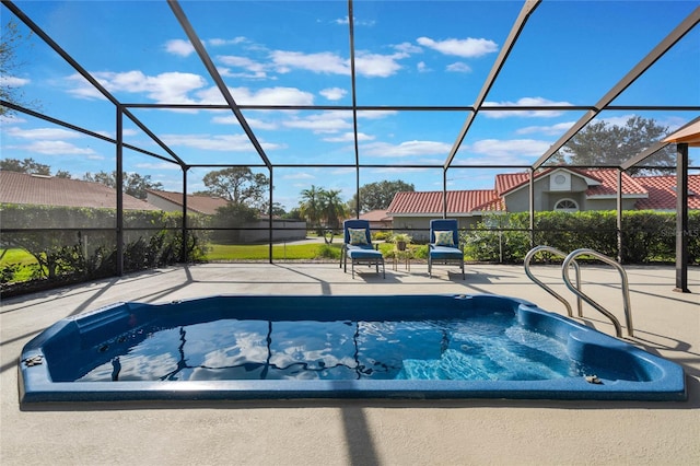 view of pool featuring a patio and glass enclosure