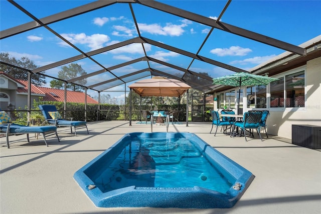 view of swimming pool featuring a patio and glass enclosure