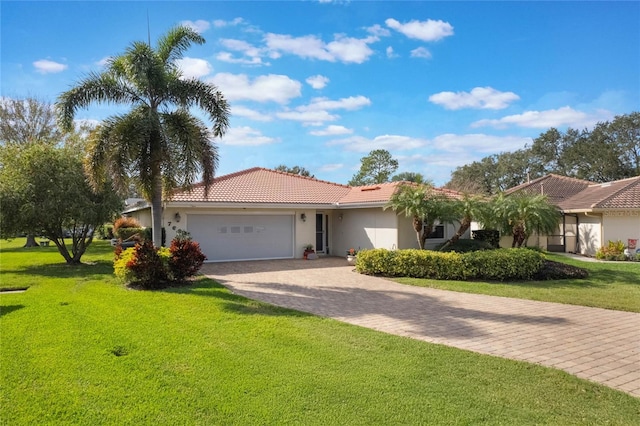 view of front facade with a garage and a front lawn